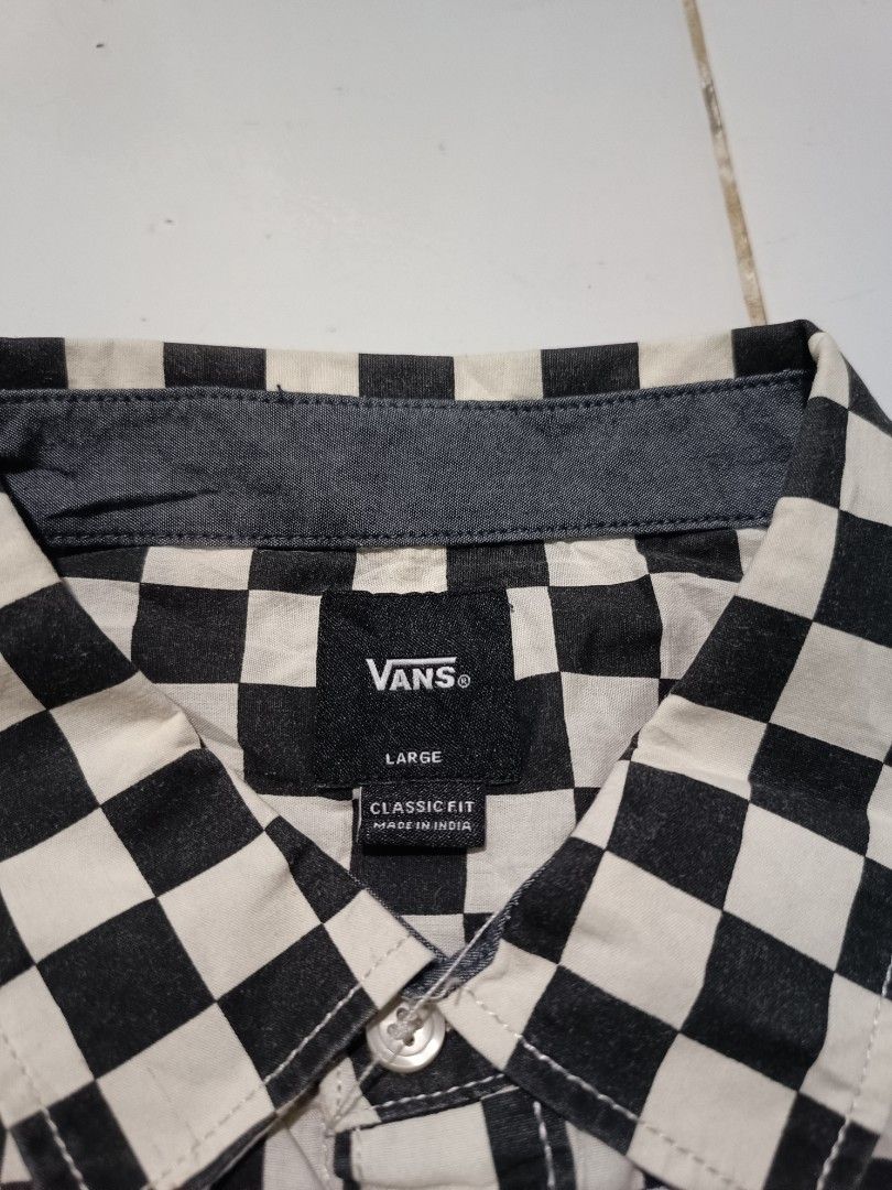 Vans Checkerboard Short Sleeve Shirt (Category: Tshirts & Polo Shirts ) located in Barotac Nuevo. Submitted by gray101 (Listing ID 1470491324, Image 3). Description: - Brand: Vans - Style: Short sleeve button-up shirt - Pattern: Classic black and white checkerboard - Size: Large (Classic Fit) - Details: Left chest pocket with Vans tag, Off The Wall label inside placket.