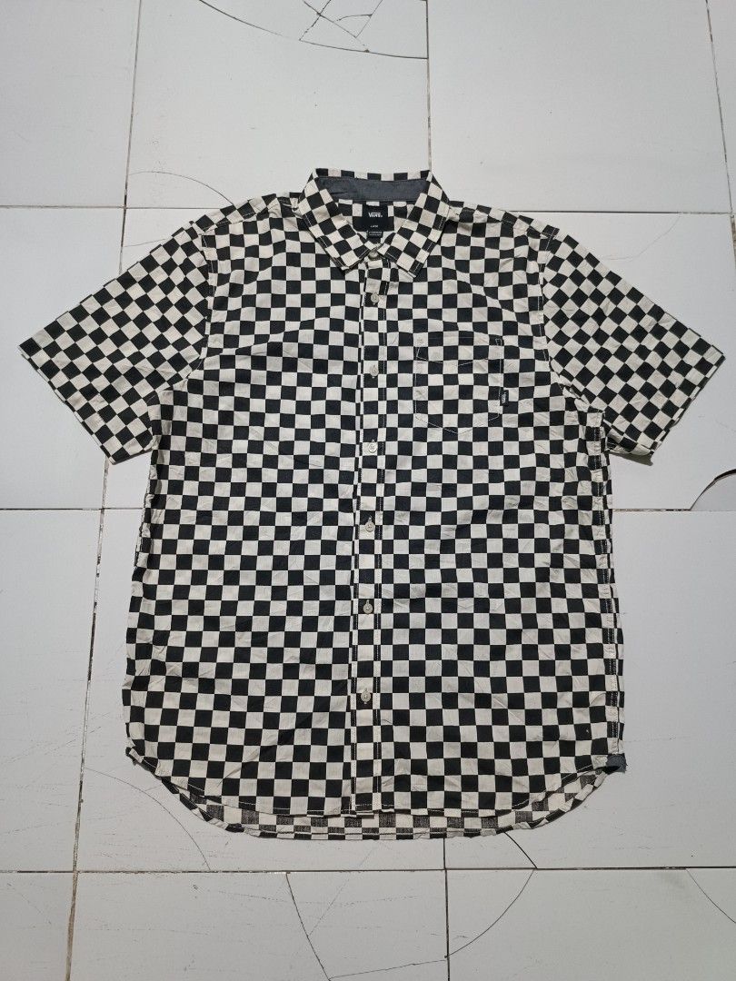 Vans Checkerboard Short Sleeve Shirt (Category: Tshirts & Polo Shirts ) located in Barotac Nuevo. Submitted by gray101 (Listing ID 1470491324, Image 1). Description: - Brand: Vans - Style: Short sleeve button-up shirt - Pattern: Classic black and white checkerboard - Size: Large (Classic Fit) - Details: Left chest pocket with Vans tag, Off The Wall label inside placket.