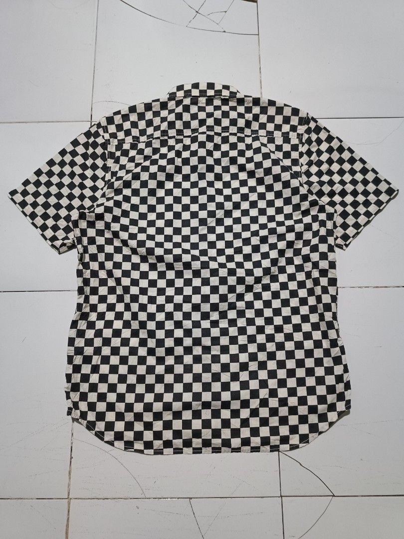 Vans Checkerboard Short Sleeve Shirt (Category: Tshirts & Polo Shirts ) located in Barotac Nuevo. Submitted by gray101 (Listing ID 1470491324, Image 2). Description: - Brand: Vans - Style: Short sleeve button-up shirt - Pattern: Classic black and white checkerboard - Size: Large (Classic Fit) - Details: Left chest pocket with Vans tag, Off The Wall label inside placket.
