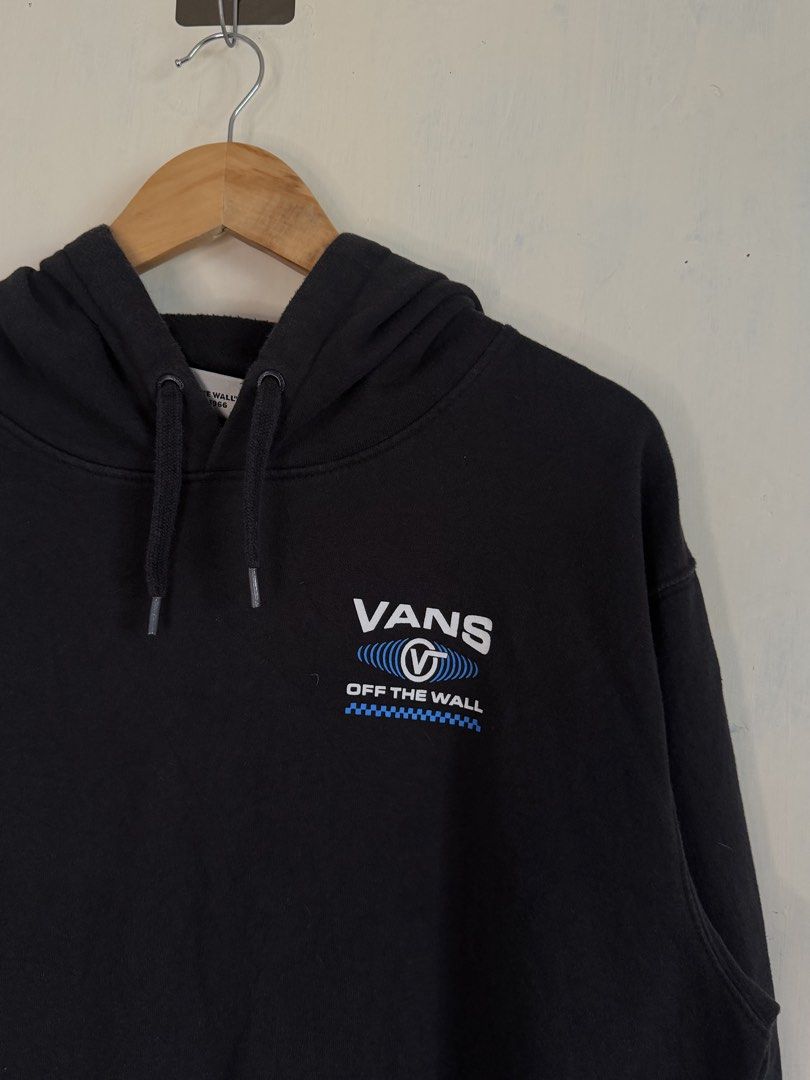 Vans Off The Wall Black Pullover Hoodie Size L (Category: Hoodies) located in Manila. Submitted by snipe.shit (Listing ID 1470422482, Image 2). Description: - Brand: Vans - Color: Black - Size: Large - Design: Classic 'Off The Wall' graphic on chest and back with blue soundwave and checkerboard details - Features: Drawstring hood and front kangaroo pocket - Material: Cotton and polyester blend - Origin: Made in Guatemala - Condition: Excellent pr