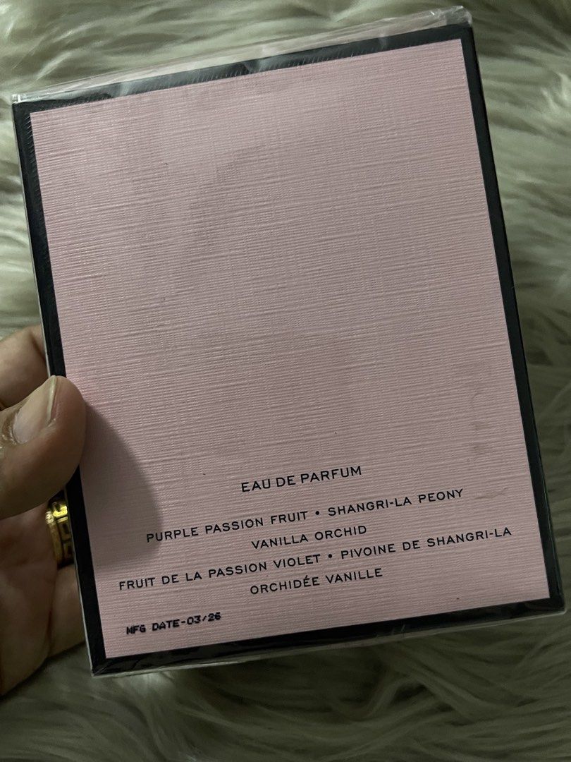 OG Victoria's Secret Bombshell Eau de Parfum 50ml (Category: Fragrance & Deodorants) located in Manila. Submitted by houseofkasheeng (Listing ID 1470351298, Image 3). Description: Victoria's Secret Bombshell eau de parfum, 50ml or 1.7 fl oz bottle. Pink textured box with gold lettering. Notes include purple passion fruit, shangri-la peony, and vanilla orchid. Plastic wrap still sealed around the packaging. Manufactured in March 2026. Distributed 