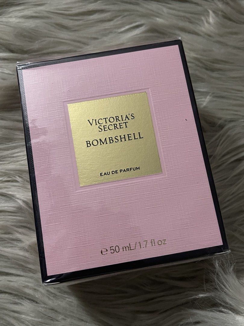 OG Victoria's Secret Bombshell Eau de Parfum 50ml (Category: Fragrance & Deodorants) located in Manila. Submitted by houseofkasheeng (Listing ID 1470351298, Image 1). Description: Victoria's Secret Bombshell eau de parfum, 50ml or 1.7 fl oz bottle. Pink textured box with gold lettering. Notes include purple passion fruit, shangri-la peony, and vanilla orchid. Plastic wrap still sealed around the packaging. Manufactured in March 2026. Distributed 