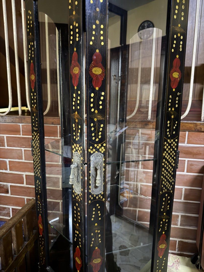 Vintage Asian Display cabinet (Category: Shelves, Cabinets & Racks) located in Makati City. Submitted by reyemv (Listing ID 1470432661, Image 2). Description: - Type: Black lacquer corner display cabinet - Design: Hand-painted gold and red floral motifs with ornate crown molding carvings - Upper Section: Glass door with 3 interior glass shelves - Lower Section: Enclosed storage compartment with double doors - Hardware: Traditional pulls included 