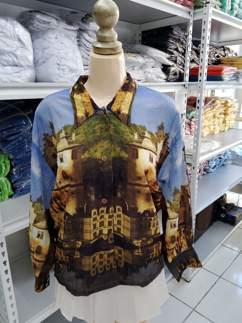 Vintage Castle Print Long Sleeve Button Down Blouse (Category: Longsleeves) located in Midsayap. Submitted by jarethshop (Listing ID 1470431018, Image 1). Description: - Style: Vintage long sleeve button-down blouse - Design: All-over medieval castle, tree, and sky graphic print - Details: Classic lapel collar and front button closure - Fit: Lightweight and relaxed - Occasion: Great statement piece for casual wear or parties - Condition: Excellen