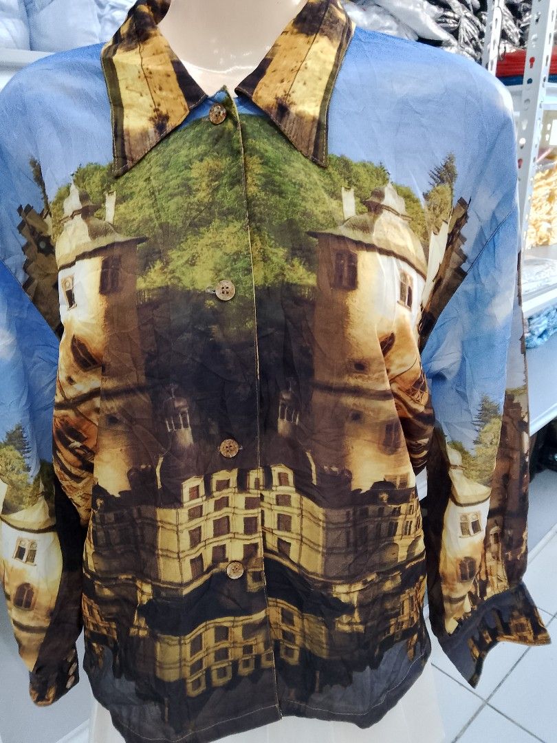 Vintage Castle Print Long Sleeve Button Down Blouse (Category: Longsleeves) located in Midsayap. Submitted by jarethshop (Listing ID 1470431018, Image 2). Description: - Style: Vintage long sleeve button-down blouse - Design: All-over medieval castle, tree, and sky graphic print - Details: Classic lapel collar and front button closure - Fit: Lightweight and relaxed - Occasion: Great statement piece for casual wear or parties - Condition: Excellen