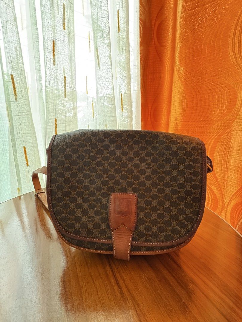 VINTAGE CELINE MACADAM SHOULDER BAG (Category: Luxury Bags & Wallets) located in Manila. Submitted by raewiee7 (Listing ID 1470424609, Image 2). Description: - Iconic Celine Macadam print shoulder bag - Classic brown and tan colorway - Genuine leather trim and strap - Features an interior zip pocket - Comes with original dust bag - A timeless and versatile accessory.