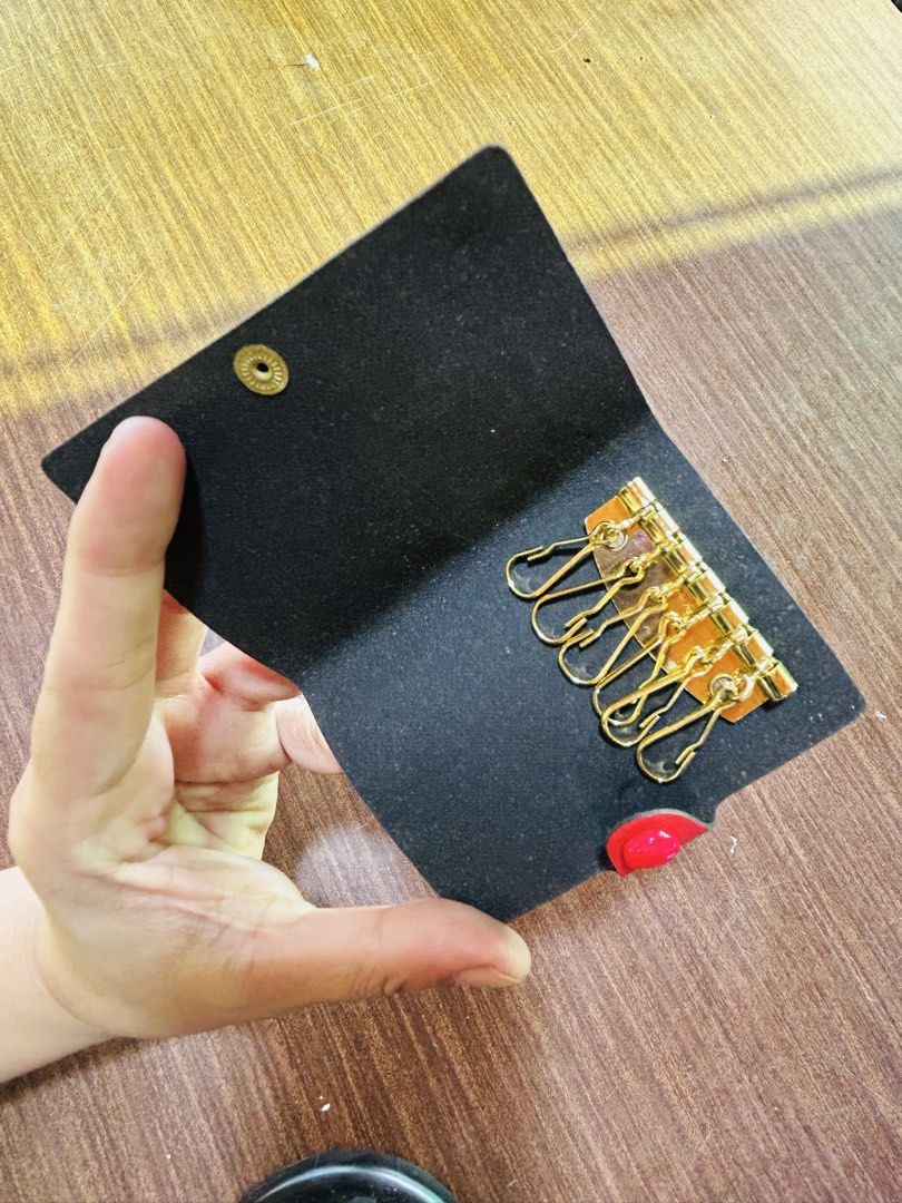 Vintage Folkestone Red Leather 6-Hook Key Case Holder (Category: Wallets & Card holders) located in Manila. Submitted by starbalesukandjapansurplus (Listing ID 1470555283, Image 3). Description: Red leather key case with gold foil Folkestone crest stamp and "Keys" lettering. Secure snap button closure. Inside has a gold-tone 6-hook hardware strip for organizing keys. Compact size fits easily in pockets or bags..
