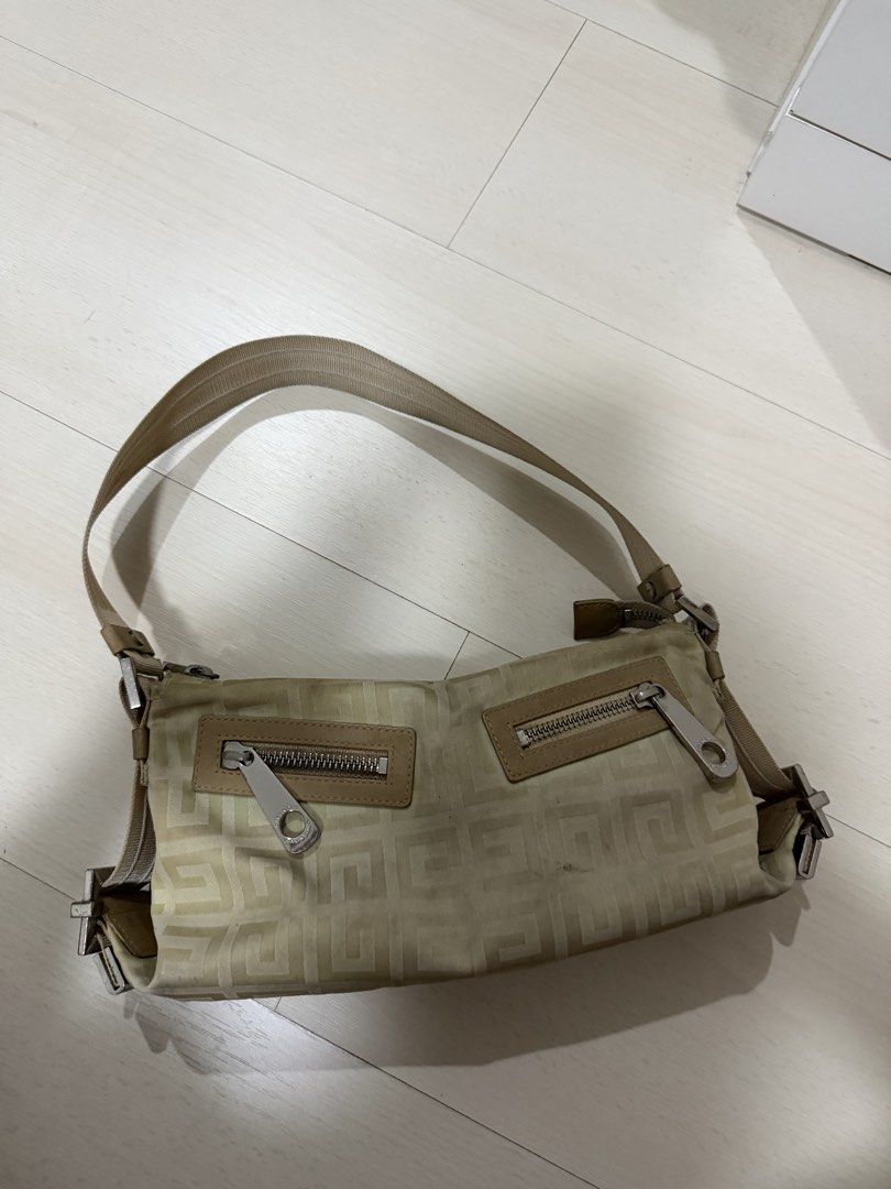 Vintage Givenchy 4G Monogram Nylon Shoulder Bag Beige (Category: Luxury Bags & Wallets) located in Las Pinas. Submitted by reijeancaraig (Listing ID 1470469341, Image 2). Description: - Authentic Givenchy shoulder bag in classic beige 4G monogram nylon - Adjustable webbed strap for comfortable wear - Secure main zip closure with two handy front zip pockets - Premium silver-tone hardware and chic leather trim details - Trendy Y2K vintage aesthetic