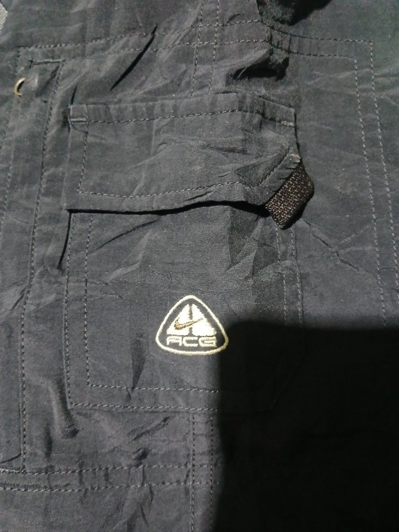 Vintage Nike ACG quick dry cargo shorts (Category: Shorts) located in San Jose. Submitted by garments17 (Listing ID 1470504899, Image 2). Description: - Brand: Nike ACG - Item: Utility Shorts - Color: Black - Size: Large (fits true) - Material: Lightweight nylon, ideal for outdoor and casual wear - Waist: Elastic with built-in adjustable web belt and buckle - Storage: Multiple side cargo pockets - Branding: Embroidered ACG triangle logo near the 