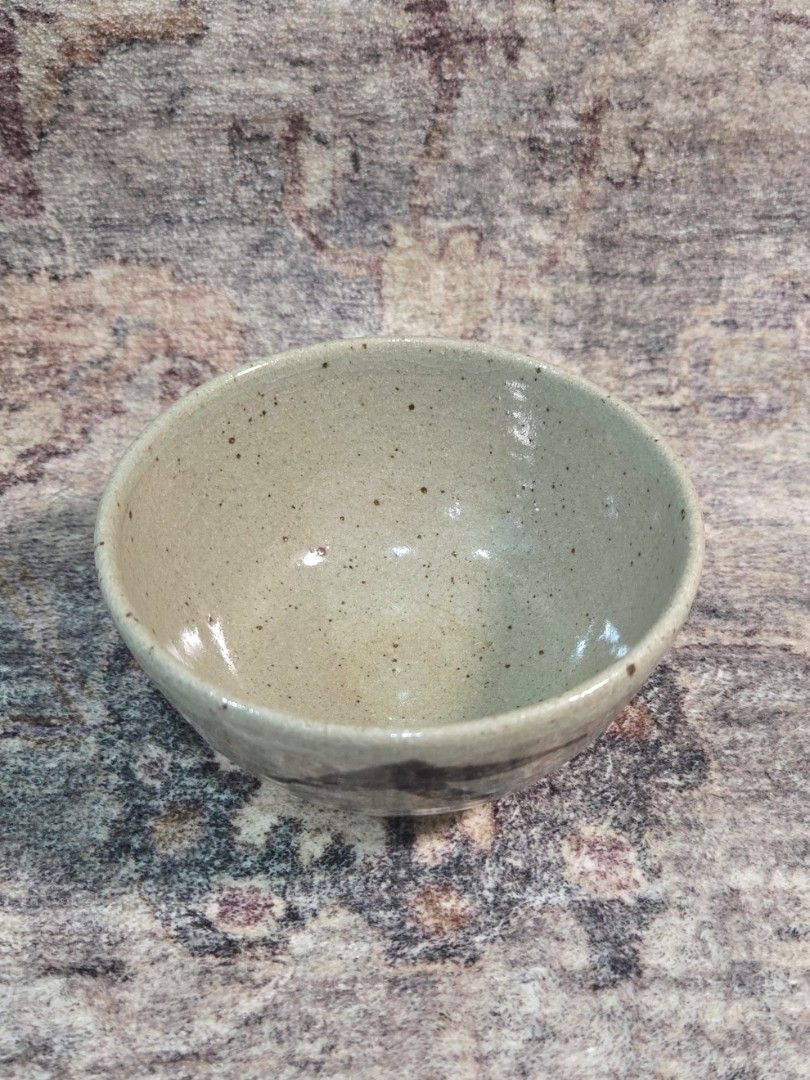 Vintage rustic studio chawan matcha bowl (Category: Coffee & Tea Tableware) located in Manila. Submitted by cwknds (Listing ID 1470514985, Image 2). Description: an authentic japanese studio tea bowl (chawan) handthrown in coarse iron clay. covered in a pale celadon-ash glaze with natural iron speckling and fine craze lines (kannyū). the base displays an undipped raw clay foot, highlighting the wabisabi contrast between glazed and unglazed textur