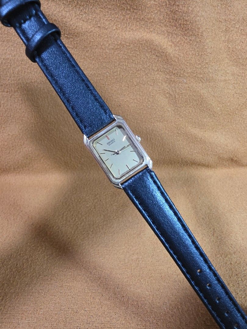 Vintage Seiko Quartz Rectangular Watch with Black Leather Strap (Category: Women's Watches) located in Rosales. Submitted by akumie30 (Listing ID 1470532275, Image 2). Description: - Authentic vintage rectangular Seiko watch imported from Japan - Elegant gold-tone case paired with a textured black leather strap - Minimalist champagne dial with clean stick markers and simple hands - Reliable quartz movement for accurate timekeeping - Versatile des