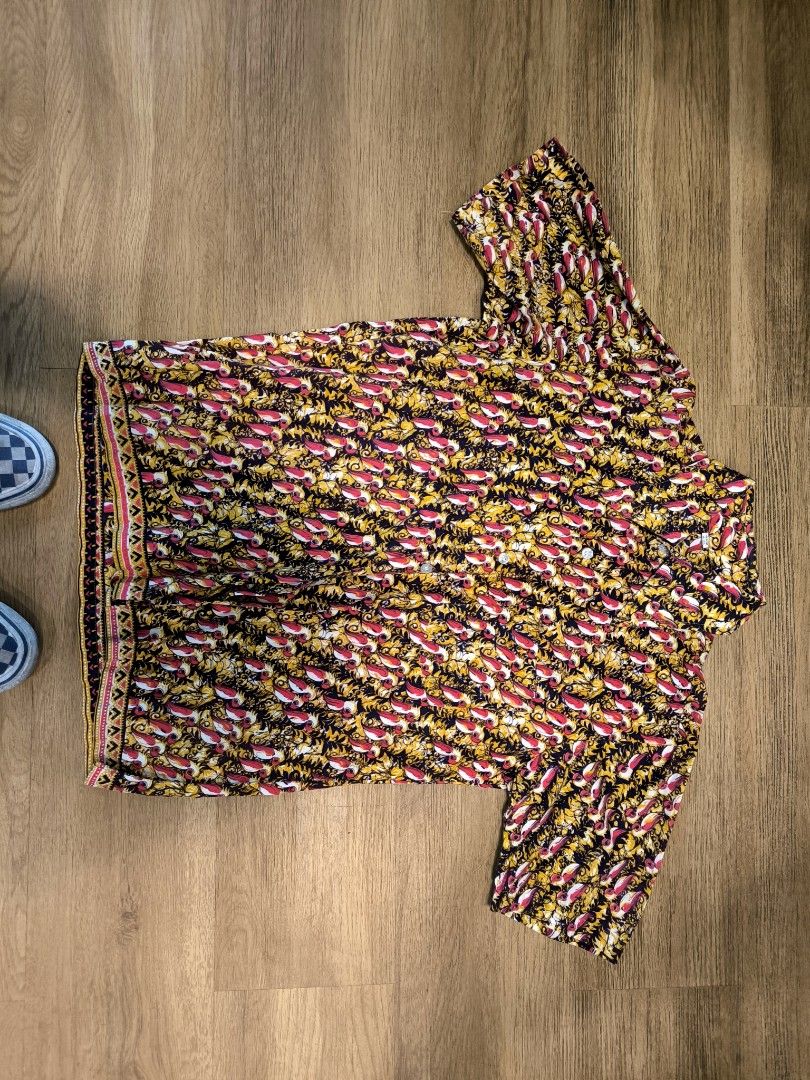 Vintage Short Sleeve Button Down Shirt Floral Pattern (Category: Formal Shirts) located in Caloocan City. Submitted by wan_l_as (Listing ID 1470459508, Image 1). Description: Short sleeve button down shirt with an all-over intricate pattern. Vibrant mix of yellow, red, and dark tones. Standard collar and front button closure. Straight hem with contrasting border details along the bottom edge. Lightweight material, comfortable for warm weather wea