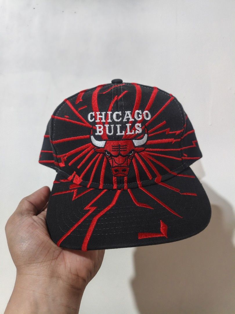 Vintage Starter Chicago Bulls Snapback Cap (Category: Caps & Hats) located in San Jose. Submitted by ezsenthrift475 (Listing ID 1470358551, Image 1). Description: - Vintage Chicago Bulls snapback by Starter - Classic black body with eye-catching red lightning bolt embroidery - Official NBA licensed product - Adjustable plastic snap closure for a custom fit - Interior features Starter branding and 'The Right Hat' tag - Material: 75% acrylic, 25% w