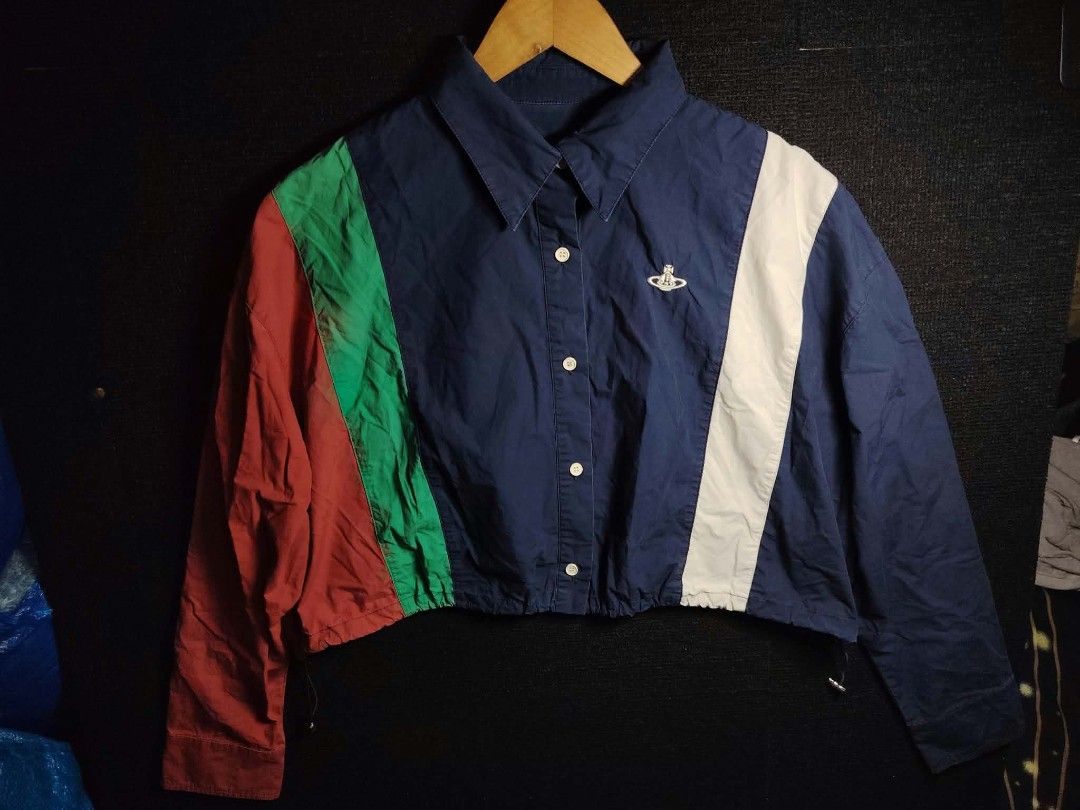 Vivienne Westwood Colorblock Button Up Cropped Jacket (Category: Coats, Jackets and Outerwear) located in Baguio. Submitted by tabuzomaria1422 (Listing ID 1470486246, Image 1). Description: - Brand: Vivienne Westwood - Design: Multi-color block with navy blue base and green, red, and white vertical stripes - Details: Signature white embroidered orb logo on the chest - Fit & Features: Collared neckline, long sleeves, button-up front, and adjustabl