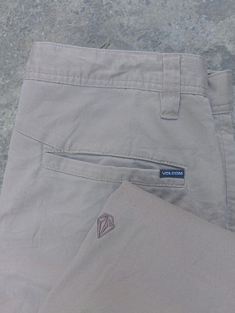 Volcom Chino Pants Size 32 -34 Khaki (Category: Chinos) located in Taguig. Submitted by mvdsh0p2022 (Listing ID 1470414558, Image 2). Description: - Brand: Volcom - Style: Casual pants / Straight fit - Color: Khaki - Size: Waist 32-34 - Material: Cotton, recycled polyester, and elastane blend for comfort - Details: Button closure with custom branding, clean stitching - Pockets: Dual back pockets (one with Volcom logo tag) - Condition: Excellent f