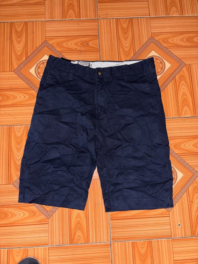 Volcom Dark Blue Chino Shorts (Category: Shorts) located in Polomolok. Submitted by rrthrift (Listing ID 1470501258, Image 1). Description: - Brand: Volcom Size 30-32 length 19 - Color: Dark blue (versatile and easy to match) - Material: Comfortable cotton blend - Closure: Button fly with branded front button - Pockets: Two front slash pockets and two back welt pockets - Details: Features a small Volcom logo tag on the back - Style: Casual everyd
