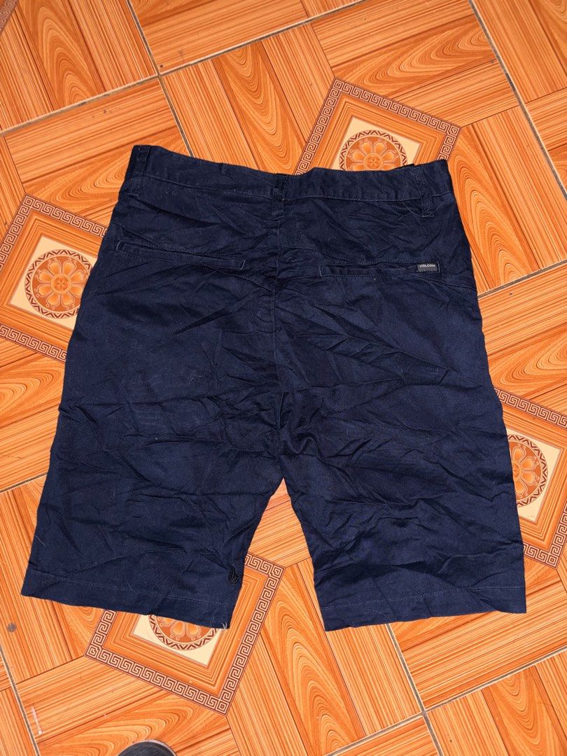 Volcom Dark Blue Chino Shorts (Category: Shorts) located in Polomolok. Submitted by rrthrift (Listing ID 1470501258, Image 2). Description: - Brand: Volcom Size 30-32 length 19 - Color: Dark blue (versatile and easy to match) - Material: Comfortable cotton blend - Closure: Button fly with branded front button - Pockets: Two front slash pockets and two back welt pockets - Details: Features a small Volcom logo tag on the back - Style: Casual everyd