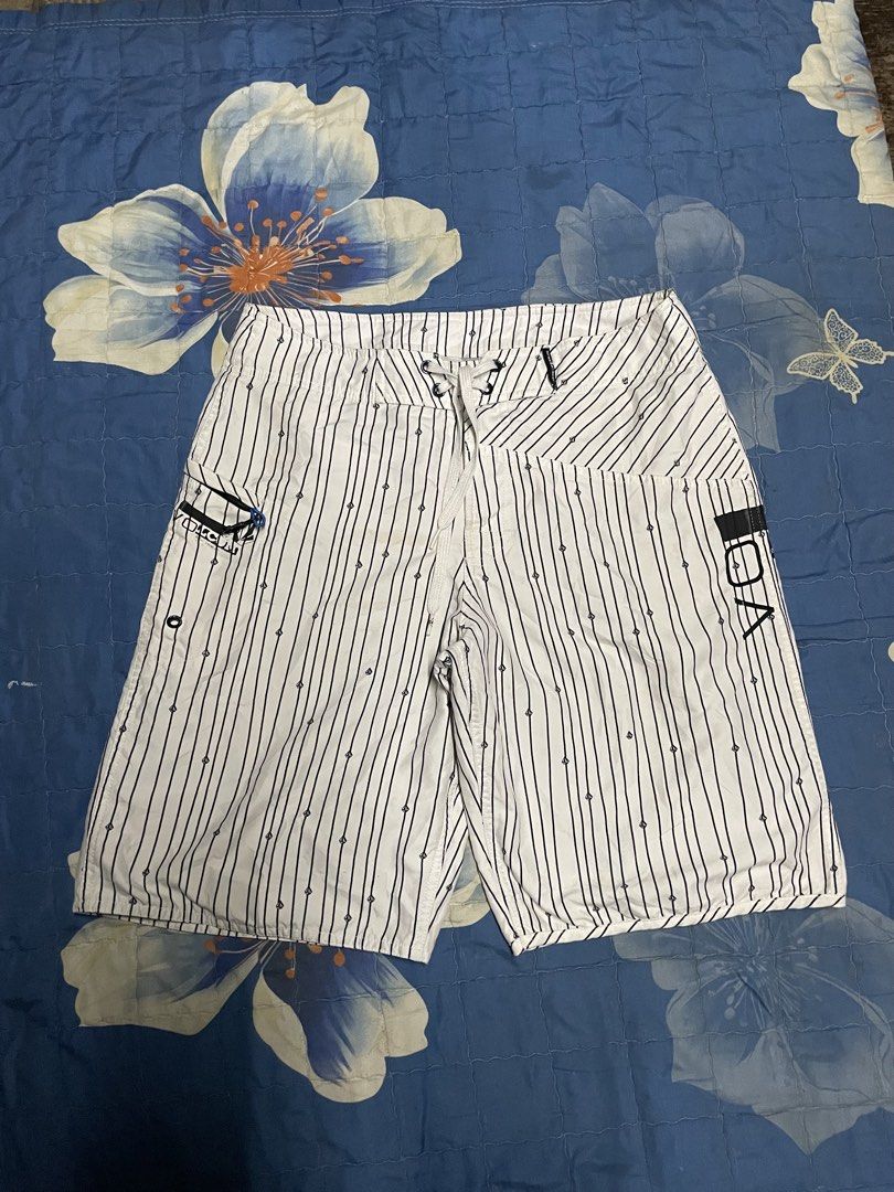 Volcom White and Black Striped Boardshorts (Category: Swim Trunks & Board Shorts) located in Manila. Submitted by chawmichael (Listing ID 1470473446, Image 1). Description: - Brand: Volcom - Color: White with vertical black pinstripes - Details: Small diamond logo prints throughout with large stone logo on left leg and back pocket - Waist: Adjustable white drawstring with secure closure - Storage: Side cargo pocket equipped with a key loop - Idea