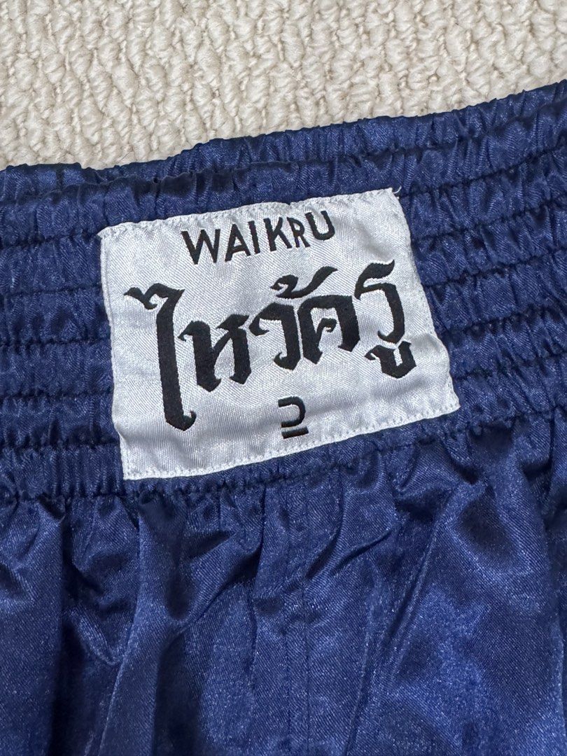 Waikru Muay Thai Shorts Blue Size 2 (Category: Shorts) located in Valenzuela. Submitted by crabncorn (Listing ID 1470351950, Image 2). Description: - Authentic Waikru Muay Thai shorts in solid blue - Traditional satin fabric with white contrast piping - Size 2 label on the wide elastic smocked waistband - Perfect for training or sparring sessions - Condition: Good / Ready to use - PM for quick transactions and shipping details.
