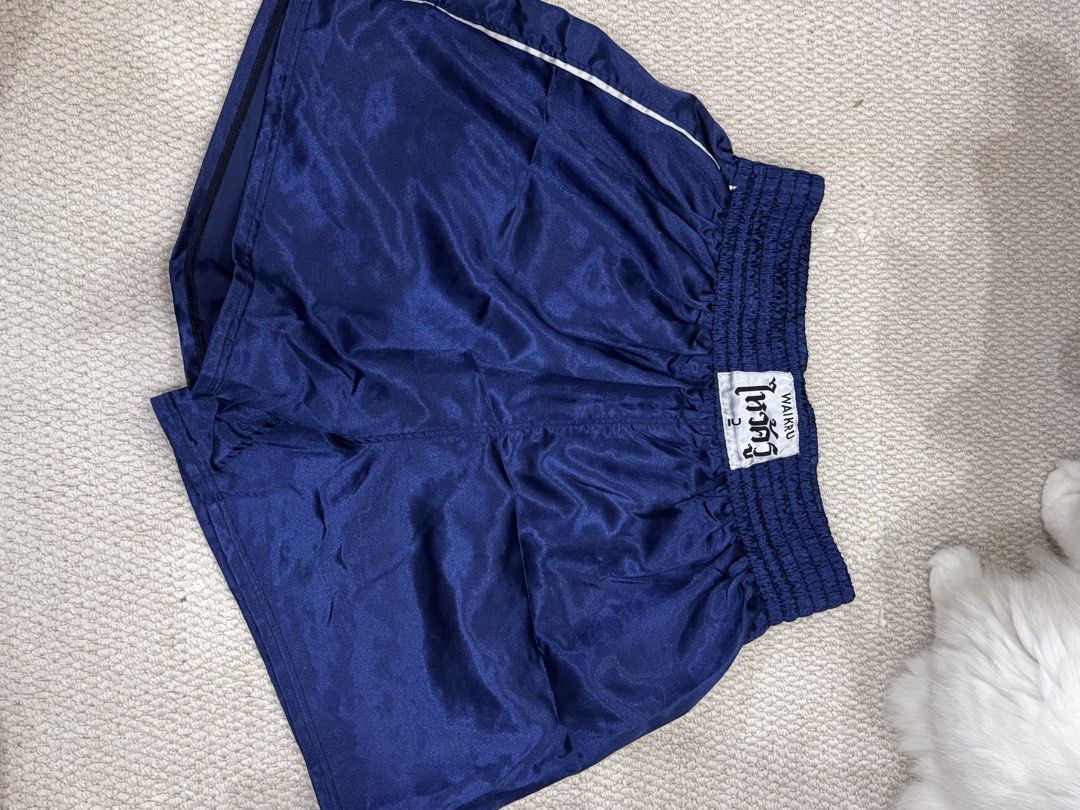 Waikru Muay Thai Shorts Blue Size 2 (Category: Shorts) located in Valenzuela. Submitted by crabncorn (Listing ID 1470351950, Image 1). Description: - Authentic Waikru Muay Thai shorts in solid blue - Traditional satin fabric with white contrast piping - Size 2 label on the wide elastic smocked waistband - Perfect for training or sparring sessions - Condition: Good / Ready to use - PM for quick transactions and shipping details.