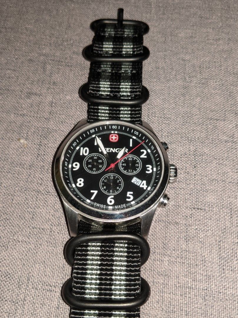 Wenger Chronograph Watch (Category: Men's Watches) located in Mandaluyong City. Submitted by bokyodgreat (Listing ID 1470404993, Image 1). Description: - Brand: Wenger - Movement: Reliable Swiss quartz movement - Dial: Classic black with clear Arabic numerals, chronograph sub-dials, and date window between 4 and 5 o'clock - Build: Sturdy stainless steel case with scratch-resistant sapphire crystal - Water Resistance: Up to 100 meters (10 ATM).