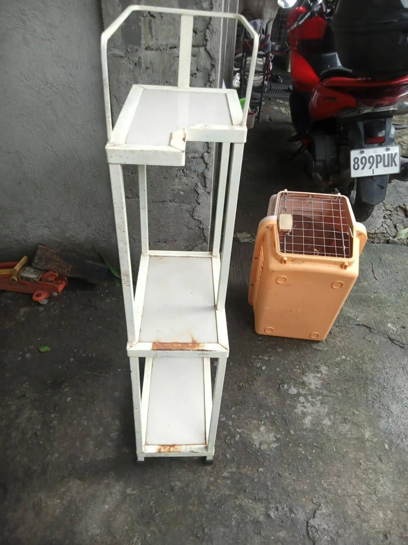 White 3-tier metal utility storage rack shelf (Category: Shelves, Cabinets & Racks) located in Manila. Submitted by wisegem-231b (Listing ID 1470421447, Image 2). Description: - Color/Material: White metal utility rack - Features: 3 shelves and top handlebar frame - Condition: Sturdy and stands upright, but has rust spots around corners and edges - Ideal Use: Great extra storage for garage, workshop, or utility areas - Design: Space-saving dimens