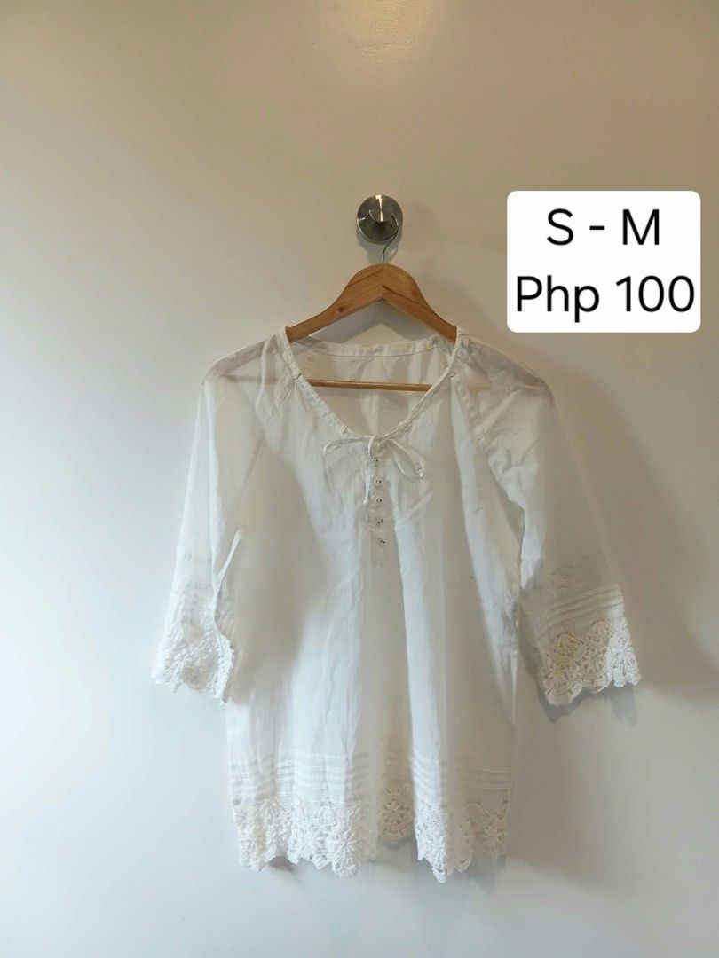 White Boho Lace Blouse (Category: Blouses) located in Antipolo. Submitted by wisecat.4a7eea (Listing ID 1470398848, Image 1). Description: - Color: White - Material: Lightweight and breathable fabric - Details: Delicate lace on hem and cuffs, tie neckline with small buttons - Sleeves: 3/4 sleeves - Size: Fits Small to Medium - Condition: Clean and ready to wear - Styling: Perfect to pair with denim shorts or skirts.