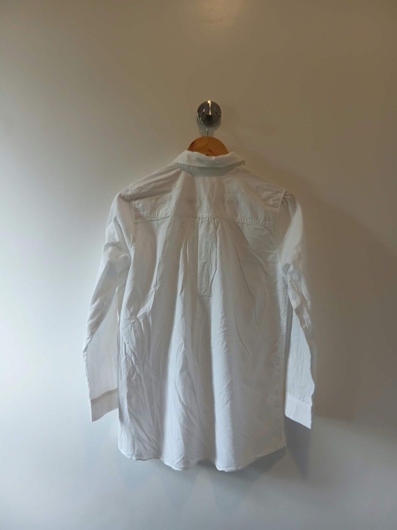 White button down shirt S-M (Category: Shirts) located in Antipolo. Submitted by wisecat.4a7eea (Listing ID 1470398687, Image 2). Description: - Color: Classic White - Fit: Fits small to medium frames - Design: Classic collar, front button closure, and single left chest pocket - Sleeves: Long sleeves with button cuffs - Fabric: Lightweight and breathable material - Versatility: Perfect for both casual and office outfits.