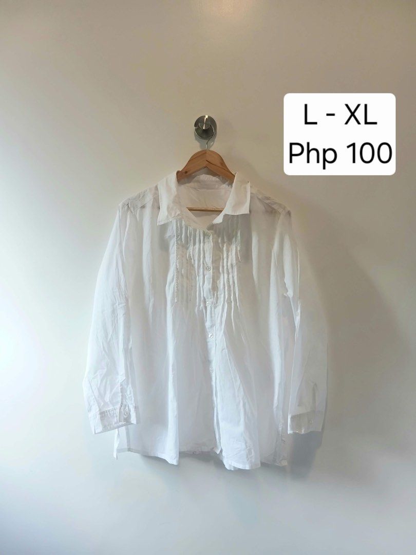 White Button-Up Blouse with Pleated Front Details L-XL (Category: Blouses) located in Antipolo. Submitted by wisecat.4a7eea (Listing ID 1470399601, Image 1). Description: - Color: White - Fit: Relaxed, fits Large to Extra Large - Style: Long-sleeve button-down with unique pleated vertical chest panels - Details: Standard collar and button cuffs - Versatility: Perfect for casual days or office wear - Fabric: Lightweight (needs a quick iron before 
