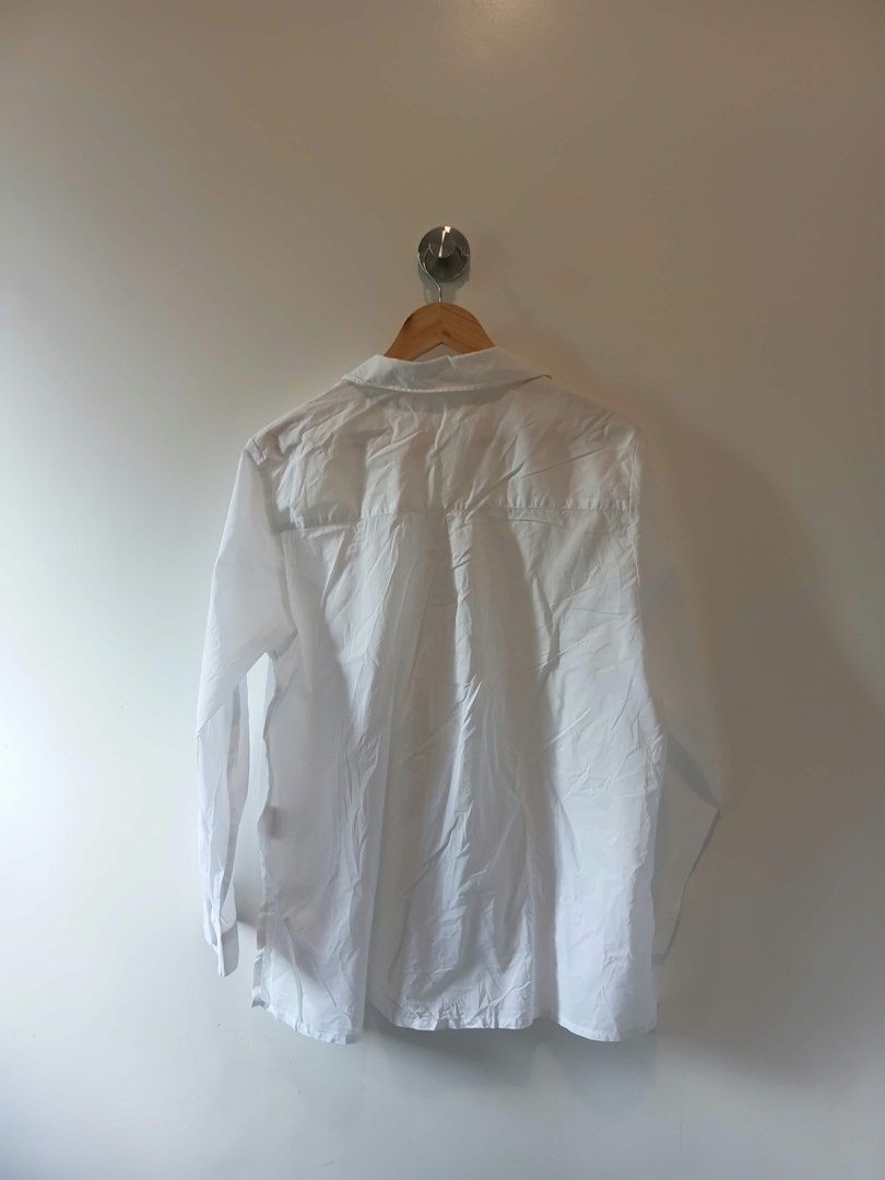 White Button-Up Blouse with Pleated Front Details L-XL (Category: Blouses) located in Antipolo. Submitted by wisecat.4a7eea (Listing ID 1470399601, Image 2). Description: - Color: White - Fit: Relaxed, fits Large to Extra Large - Style: Long-sleeve button-down with unique pleated vertical chest panels - Details: Standard collar and button cuffs - Versatility: Perfect for casual days or office wear - Fabric: Lightweight (needs a quick iron before 