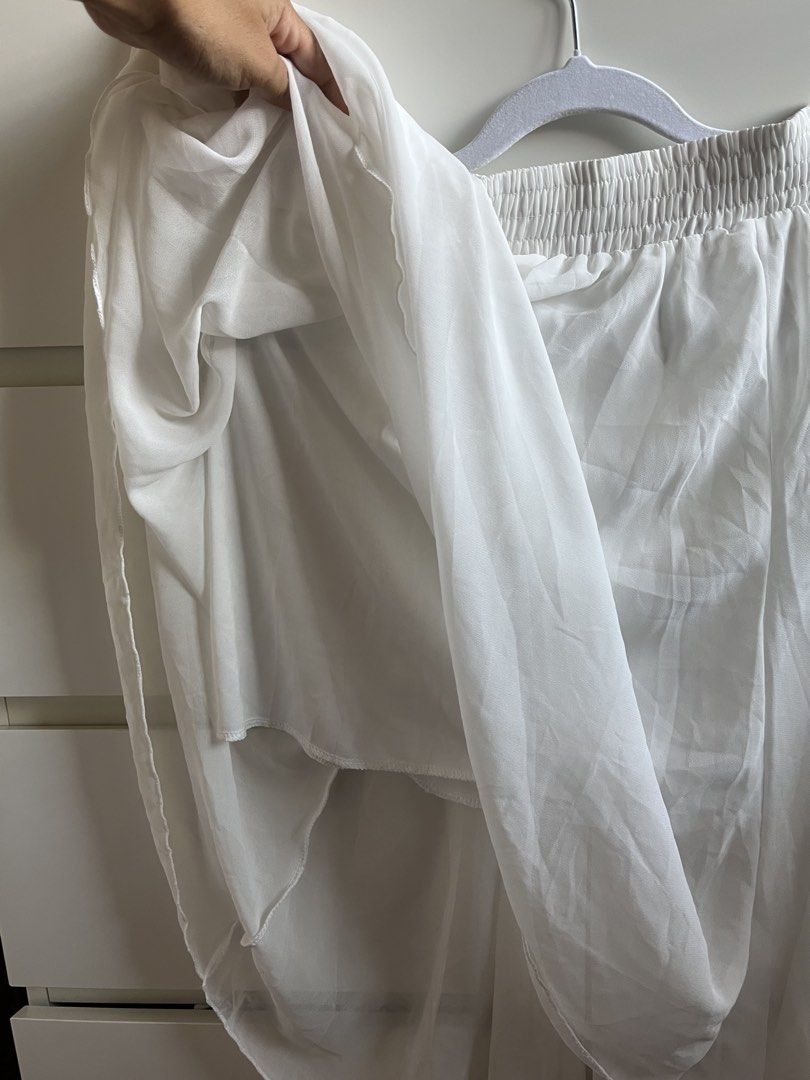 White Chiffon Midi Skirt (Category: Skirts) located in Taytay. Submitted by prelovedbyblaire (Listing ID 1470385070, Image 2). Description: - Color: White - Material: Light chiffon with full lining (not see-through) - Waist: Stretchy elastic waistband, slip-on style - Design: Pleated texture with a flowy drape - Fit: Midi length, great basic piece for warm weather.
