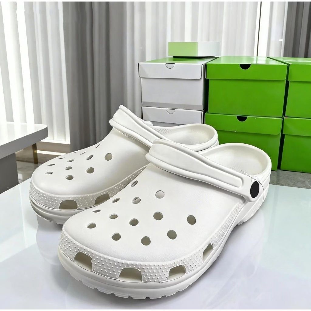 White Classic Clogs (Category: Casual shoes) located in Puchong. Submitted by royalstar_3f558c (Listing ID 1470406421, Image 3). Description: - Color: Classic White - Condition: Brand new with original box and tags attached - Features: Ventilation ports on top and sides for breathability, textured mudguard, and pivoting heel strap with embossed logo - Material: Lightweight and water-friendly - Perfect for daily wear, casual outings, or rainy days