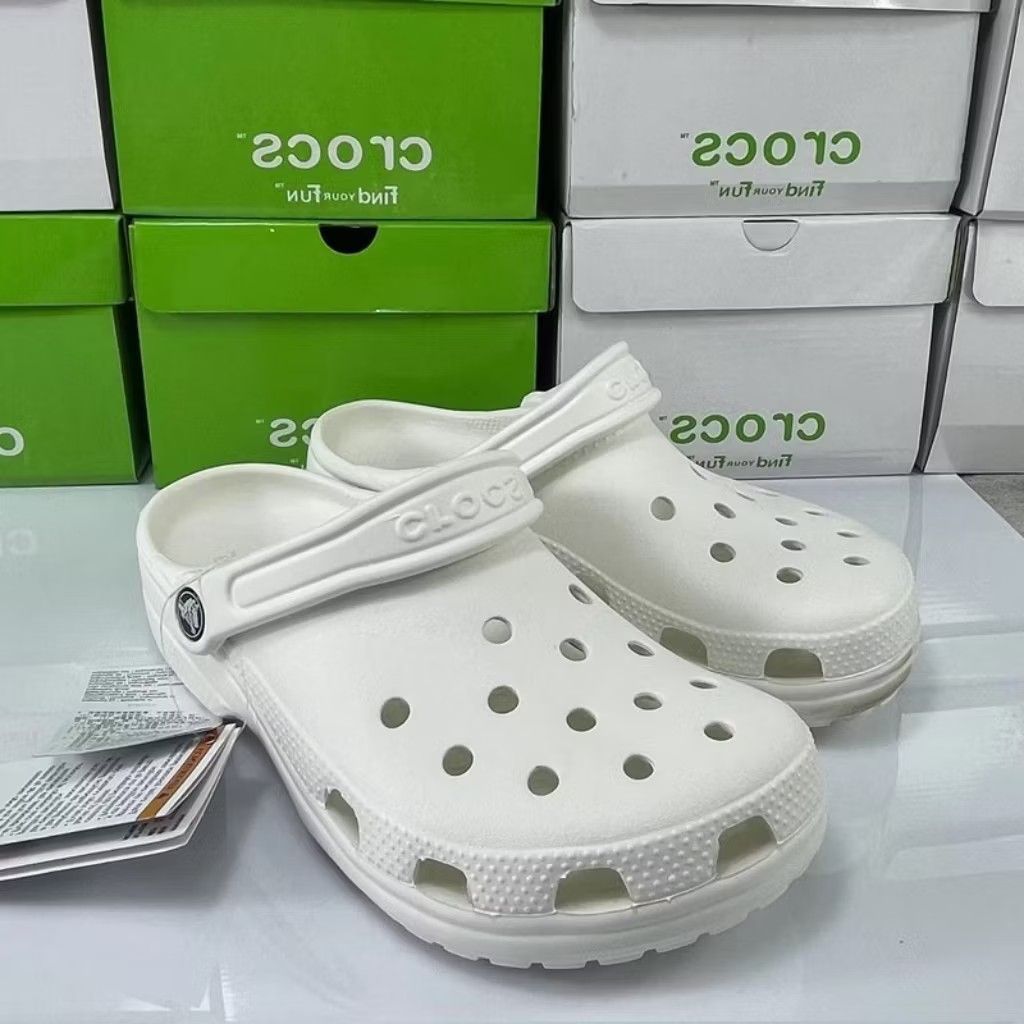 White Classic Clogs (Category: Casual shoes) located in Puchong. Submitted by royalstar_3f558c (Listing ID 1470406421, Image 2). Description: - Color: Classic White - Condition: Brand new with original box and tags attached - Features: Ventilation ports on top and sides for breathability, textured mudguard, and pivoting heel strap with embossed logo - Material: Lightweight and water-friendly - Perfect for daily wear, casual outings, or rainy days
