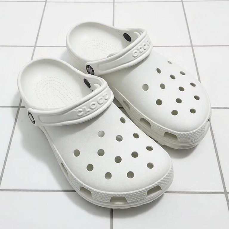 White Classic Clogs (Category: Casual shoes) located in Puchong. Submitted by royalstar_3f558c (Listing ID 1470406421, Image 1). Description: - Color: Classic White - Condition: Brand new with original box and tags attached - Features: Ventilation ports on top and sides for breathability, textured mudguard, and pivoting heel strap with embossed logo - Material: Lightweight and water-friendly - Perfect for daily wear, casual outings, or rainy days