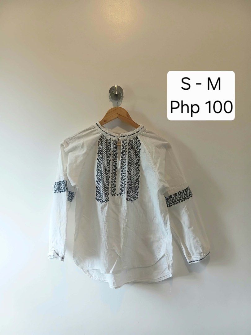 White Embroidered Long Sleeve Blouse Size S-M (Category: Longsleeves) located in Antipolo. Submitted by wisecat.4a7eea (Listing ID 1470398375, Image 1). Description: - Color: White with dark blue embroidery - Design: Long-sleeve, loose fit - Details: Keyhole front closure with a single white button - Condition: Clean and ready to wear.