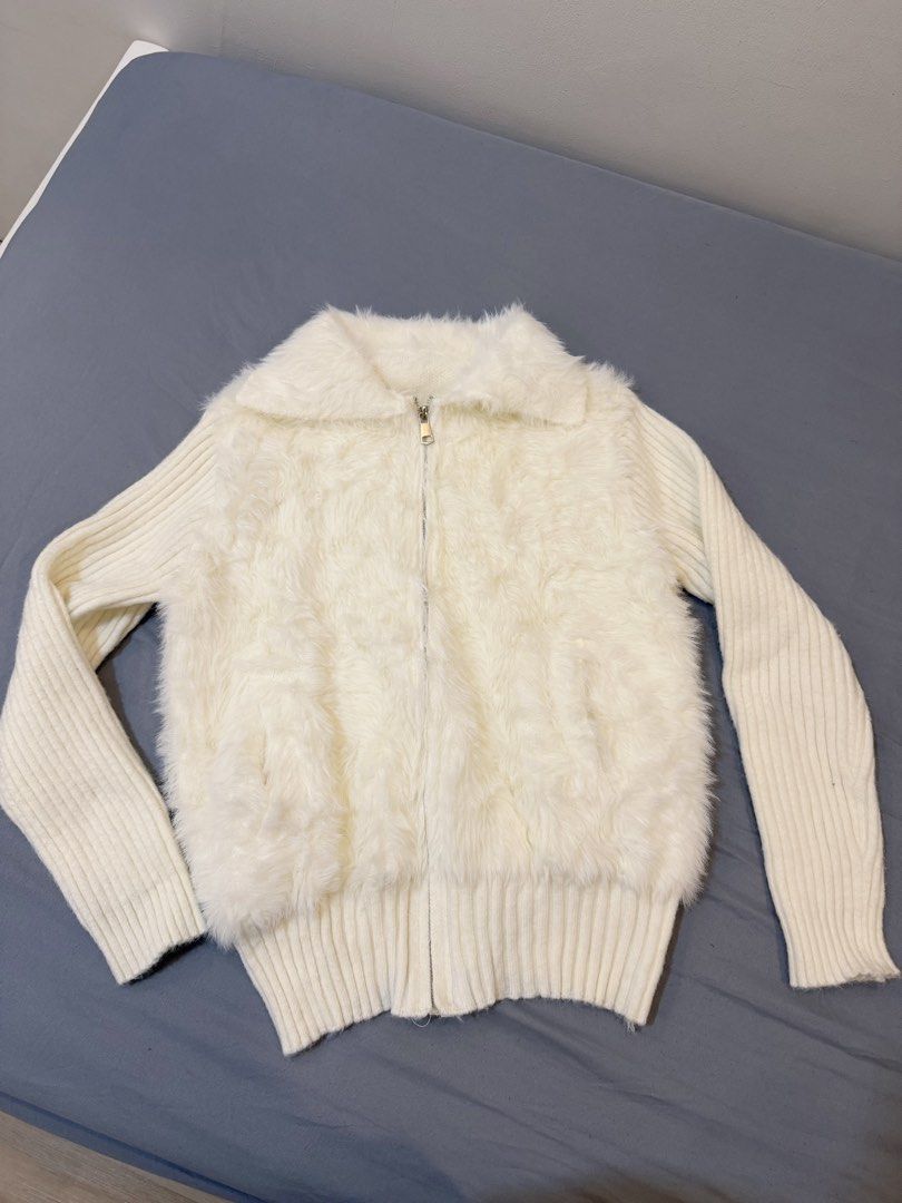 White fluffy zip-up jacket with knit sleeves (Category: Coats, Jackets and Outerwear) located in Rizal. Submitted by tomatoramenn (Listing ID 1470411255, Image 2). Description: - Color: White - Material: Fluffy faux fur body with ribbed knit sleeves and collar - Closure: Full front zipper - Condition: Worn once for photosi, excellent shape and super clean - Features: Warm, cozy texture, ideal for layering in cold weather Perfect for winter outfit