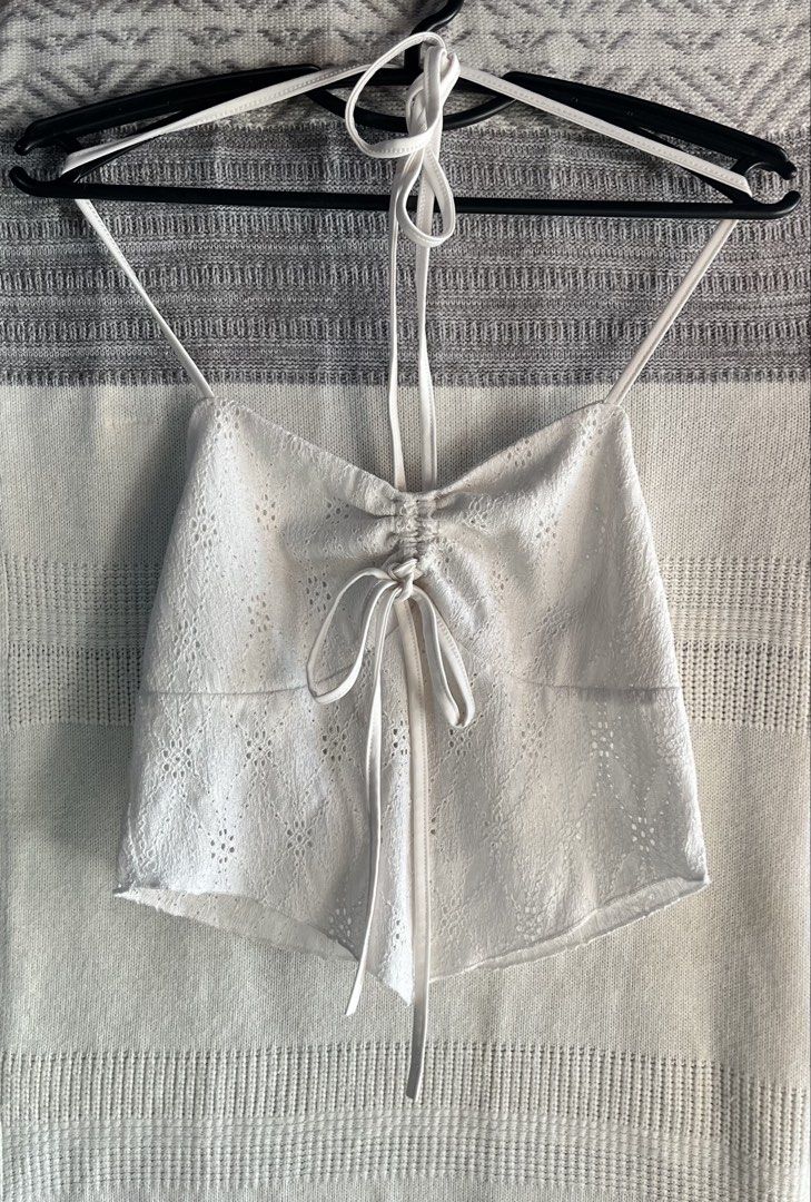 White Halter Neck Eyelet Crop Top with Drawstring (Category: Sleeveless) located in General Mariano Alvarez. Submitted by kascade (Listing ID 1470440305, Image 1). Description: - Style: Halter neck crop top with delicate eyelet embroidery - Details: Adjustable drawstring front, ruched center, thin spaghetti straps, open back - Material: Lightweight and breathable fabric - Versatility: Great for warm weather or layering 💵 Payment: GCash/MariBank 