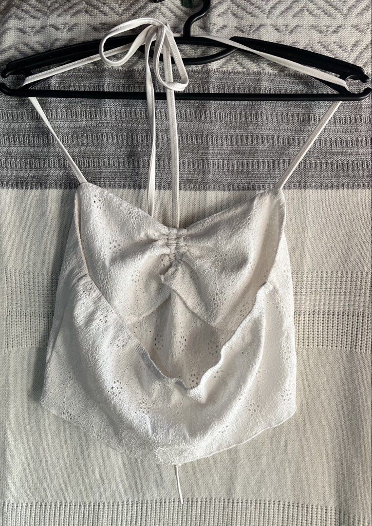 White Halter Neck Eyelet Crop Top with Drawstring (Category: Sleeveless) located in General Mariano Alvarez. Submitted by kascade (Listing ID 1470440305, Image 2). Description: - Style: Halter neck crop top with delicate eyelet embroidery - Details: Adjustable drawstring front, ruched center, thin spaghetti straps, open back - Material: Lightweight and breathable fabric - Versatility: Great for warm weather or layering 💵 Payment: GCash/MariBank 