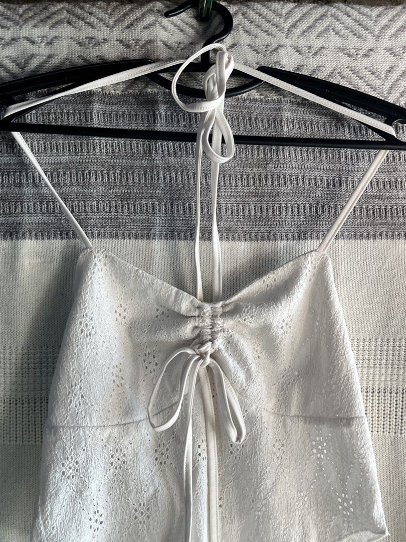 White Halter Neck Eyelet Crop Top with Drawstring (Category: Sleeveless) located in General Mariano Alvarez. Submitted by kascade (Listing ID 1470440305, Image 3). Description: - Style: Halter neck crop top with delicate eyelet embroidery - Details: Adjustable drawstring front, ruched center, thin spaghetti straps, open back - Material: Lightweight and breathable fabric - Versatility: Great for warm weather or layering 💵 Payment: GCash/MariBank 