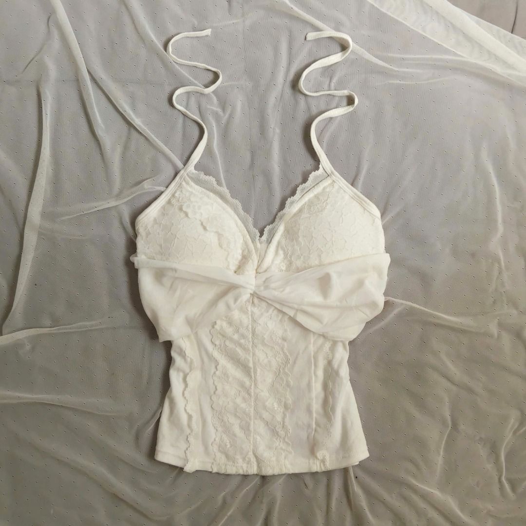 White Halter Neck Lace Top (Category: Sleeveless) located in Manila. Submitted by electricpetals (Listing ID 1470475538, Image 1). Description: - Color: White - Size: XS-M (Stretchable) - Style: Slim fit halter neck camisole - Design: Soft draped fabric across the chest with adjustable tie straps - Condition: Brand new / Excellent.