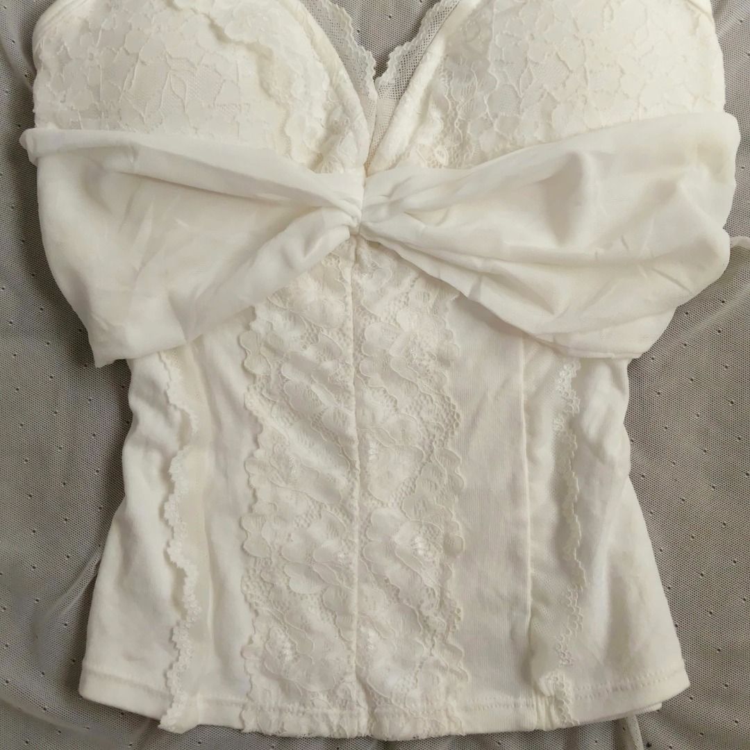 White Halter Neck Lace Top (Category: Sleeveless) located in Manila. Submitted by electricpetals (Listing ID 1470475538, Image 3). Description: - Color: White - Size: XS-M (Stretchable) - Style: Slim fit halter neck camisole - Design: Soft draped fabric across the chest with adjustable tie straps - Condition: Brand new / Excellent.