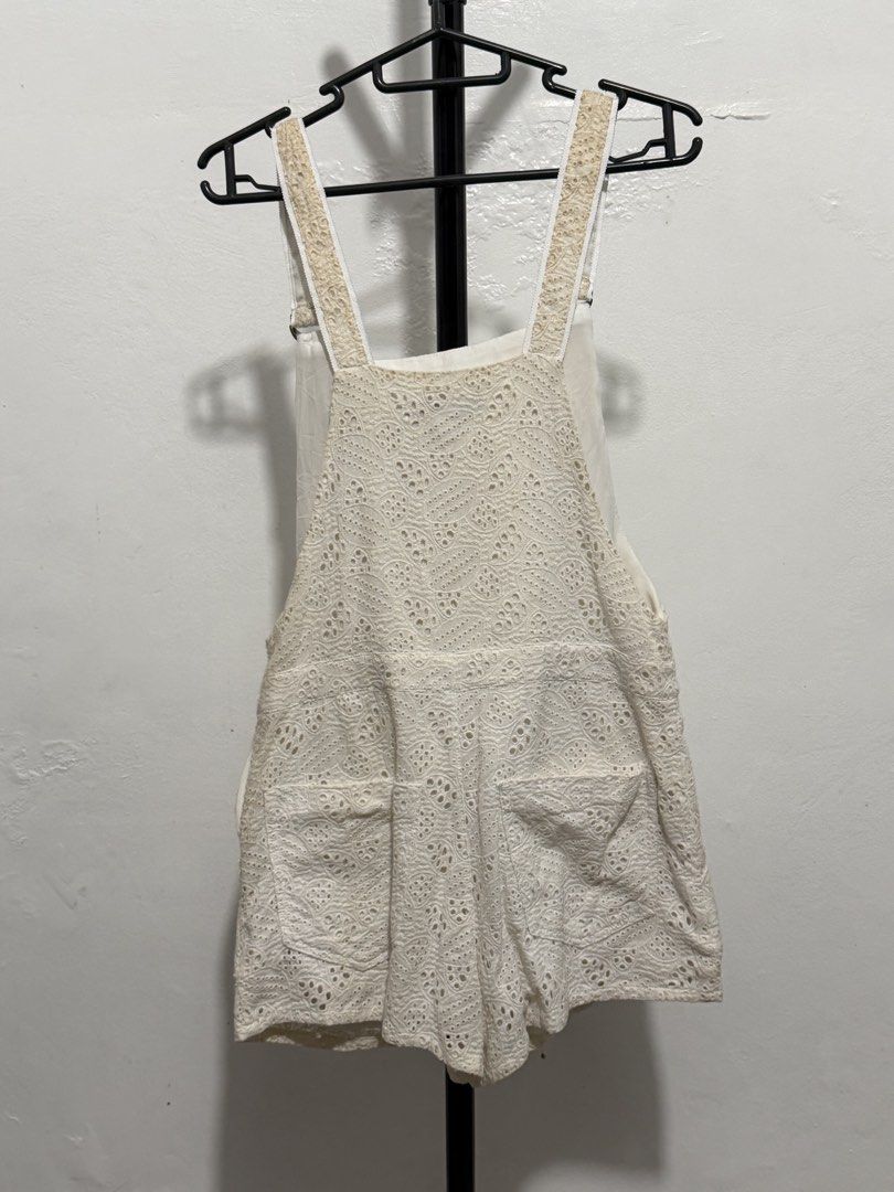 White lace overall shorts with front pockets (Category: Rompers) located in Mandaluyong City. Submitted by jdflores17 (Listing ID 1470456978, Image 1). Description: - White lace overall shorts with detailed eyelet patterns - Adjustable shoulder straps with metal rings for a custom fit - Functional front bib pocket and two back pockets - Lightweight, breathable fabric perfect for sunny days - Easy pullover style for effortless wear.