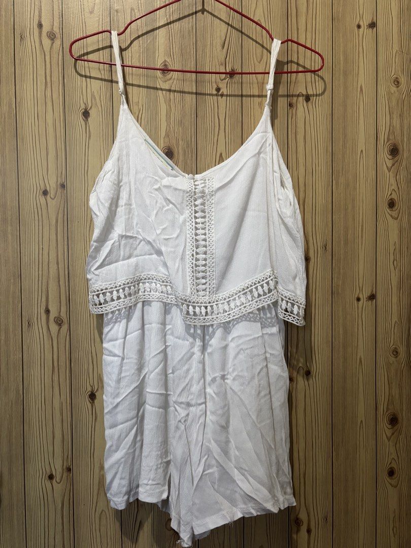 White lace trim spaghetti strap romper playsuit (Category: Rompers) located in Manila. Submitted by yas__ (Listing ID 1470434028, Image 1). Description: - Color: White - Needs cleaning and ironing - Style: Sleeveless romper with easy slip-on design - Details: Delicate lace crochet trim on front and overlay hem - Straps: Adjustable spaghetti straps - Back: Open back cutout with top button closure - Material: Lightweight and breathable fabric - Per