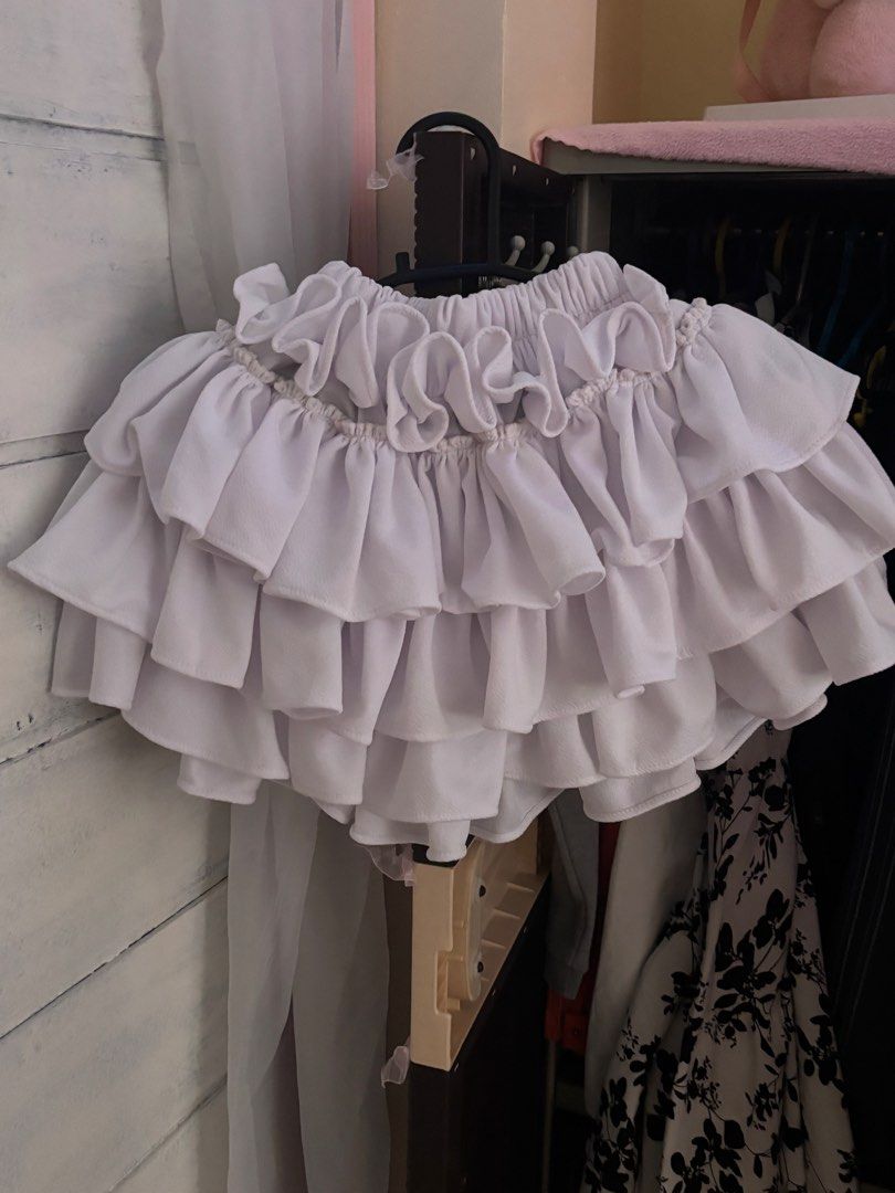 White Layered Ruffle Tutu Skirt (Category: Dresses) located in Real. Submitted by fleure.wardrobe.classical.shop (Listing ID 1470436837, Image 2). Description: white layered ruffle tutu skirt features multiple tiers of soft, gathered fabric that create a voluminous and playful silhouette. It is designed with an elasticized waistband for a comfortable, flexible fit, making it perfect for dress-up, dance routines, costuming, or adding a whimsical t