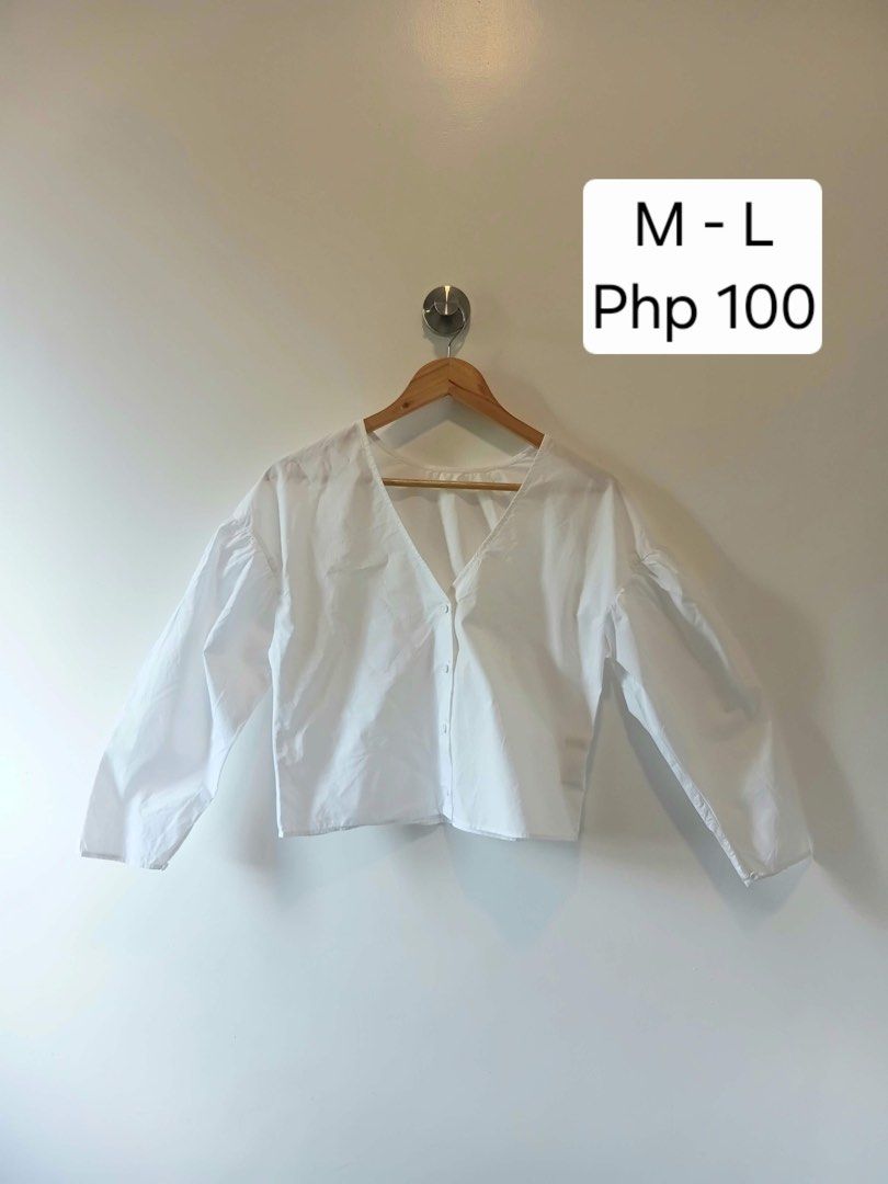 White long sleeve button down blouse (Category: Longsleeves) located in Antipolo. Submitted by wisecat.4a7eea (Listing ID 1470399709, Image 1). Description: - Color: White - Style: Clean, minimal design with front button closures - Details: V-neckline, trendy puffed sleeves, and gathered back accent - Fit: Comfortable medium to large (M-L) - Versatility: Easy to style with both skirts and trousers.