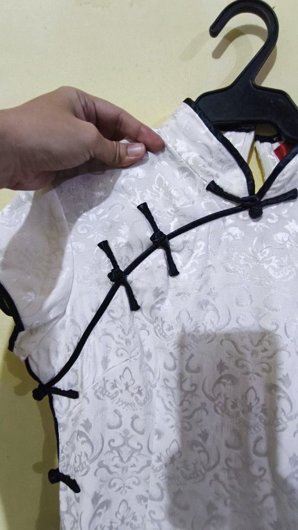 White Mandarin Collar Mini Dress Traditional (Category: Dresses) located in Manila. Submitted by jnhviola (Listing ID 1470437897, Image 2). Description: - Color: White with intricate silver brocade pattern - Design: Traditional mandarin collar, decorative fabric knot buttons, and contrasting black piping - Fit: Structured short-sleeve mini dress - Closure: Concealed back zipper for easy wear - Condition: PRELOVED; LIKED-NEW - Mode of Payment: BDO