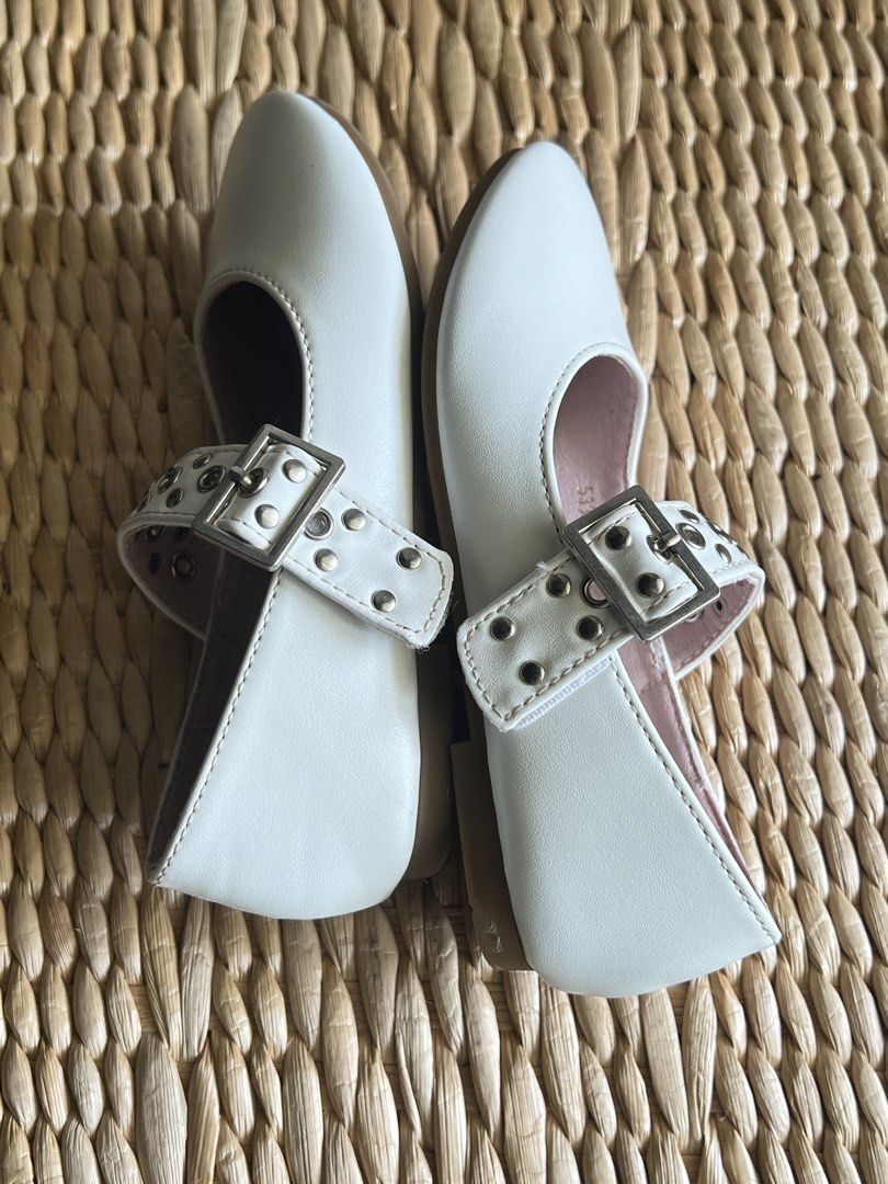 White Mary Jane Flat Shoes with Studded Straps (Category: Babies & Kids Fashion) located in San Fernando. Submitted by wearvfs (Listing ID 1470516991, Image 2). Description: - Color: White with soft pink inner lining - Design: Studded strap detail with silver side buckle closure - Size: EU 28 (approx. 18.5 cm outsole length) - Condition: Excellent, barely worn, clean soles .