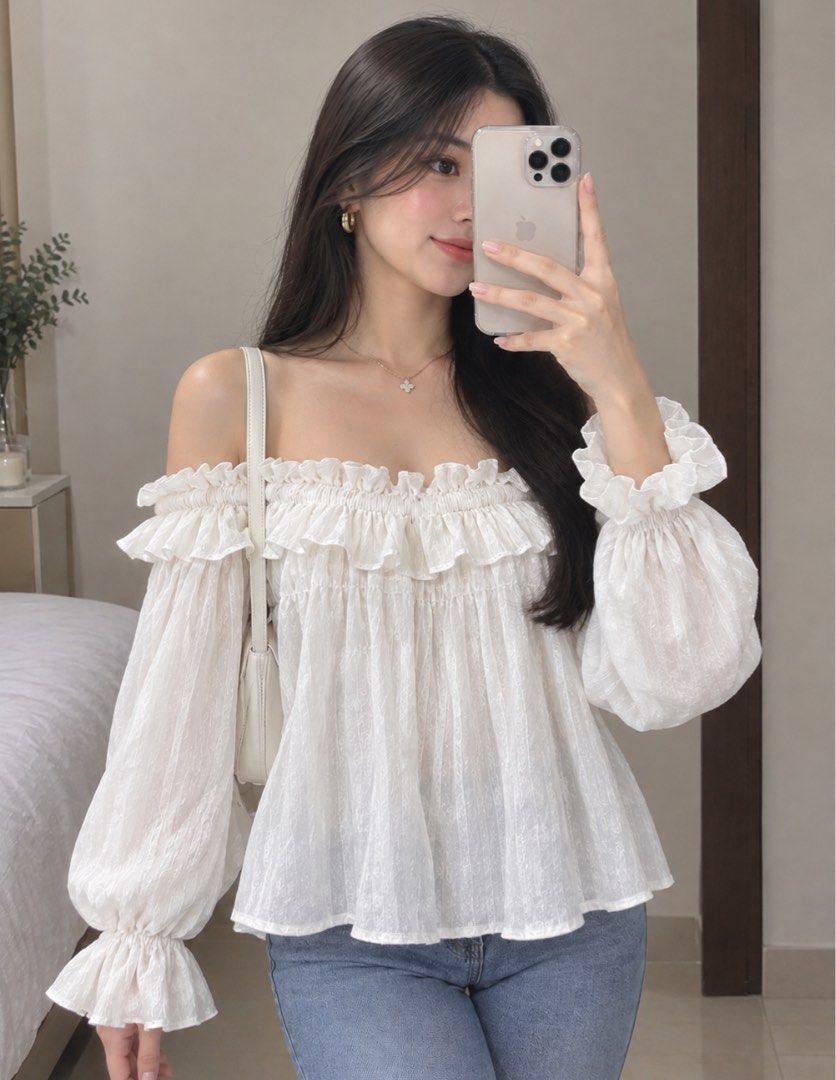 White Pleated Cami Top with Ruffle Details (Category: Sleeveless) located in Tabuk. Submitted by zenwolf-1867 (Listing ID 1470532233, Image 1). Description: - Color: White - Style: Sleeveless cami top with thin spaghetti straps - Material: Lightweight, shiny, and textured pleated fabric - Design details: Ruffled neckline and stylish flowy fit with extra draped side panels - Perfect for layering or casual sunny days!.