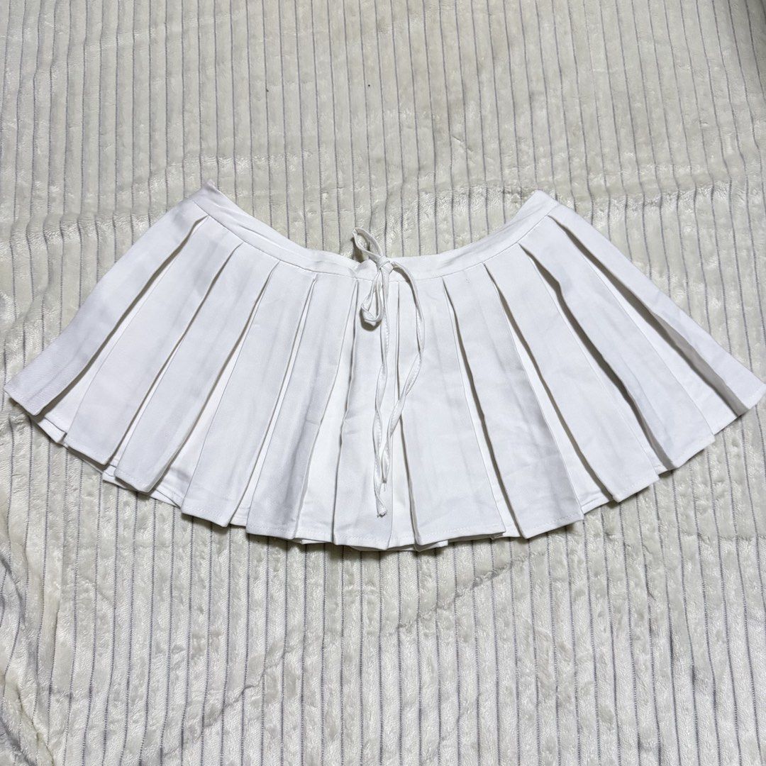White Pleated Tennis Skirt (Category: Skirts) located in Manila. Submitted by ish.vintage (Listing ID 1470488961, Image 1). Description: - White Pleated Skirt - With built-in shorts underneath - Front Ties and zipper enclosure at the back - W: 32in, L: 11in - Versatile piece that can easily be styled with shirts for a sporty look or dainty blouses for dressier outfits - Worn only once for a concert .