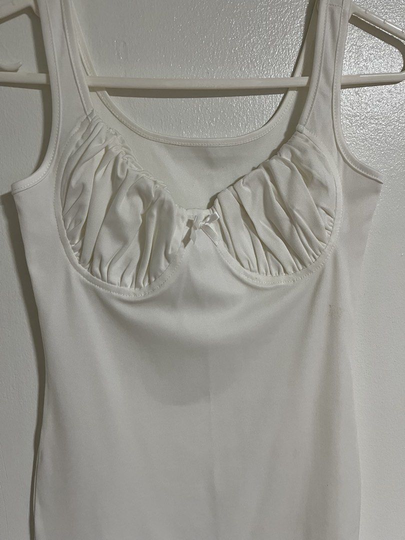White Ruched Bust Bodycon Mini Dress with Bow (Category: Dresses) located in Cabuyao City. Submitted by rdtrmt (Listing ID 1470440902, Image 2). Description: - Color: White - Style: Sleeveless bodycon mini dress - Neckline: Scooped with ruched bust detailing and center bow accent - Straps: Standard tank straps - Back: Plain and solid white - Fit: Form-fitting silhouette - Condition: still in good condition .